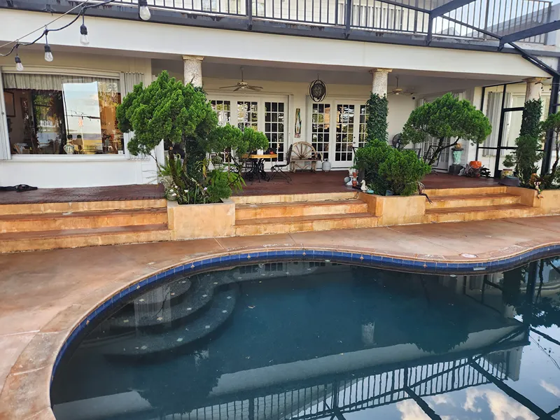 Spotless backyard area after pool deck pressure washing