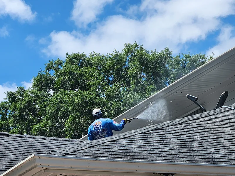 Pressure washing roof soffits and gutters on an Orlando estate